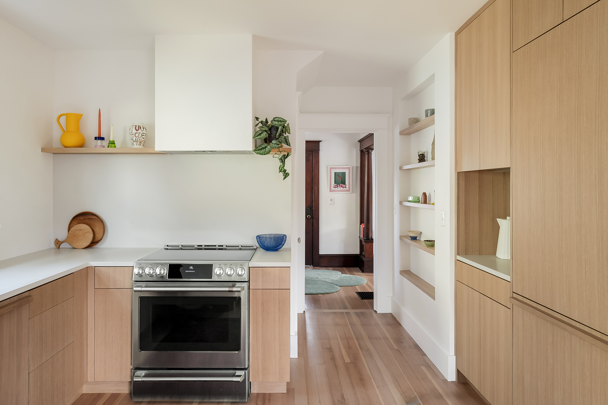 Range and built-in vent hood with floating oak shelf, looking toward the hallway, Alameda Kitchen remodel by Tweto Architecture, NE Portland