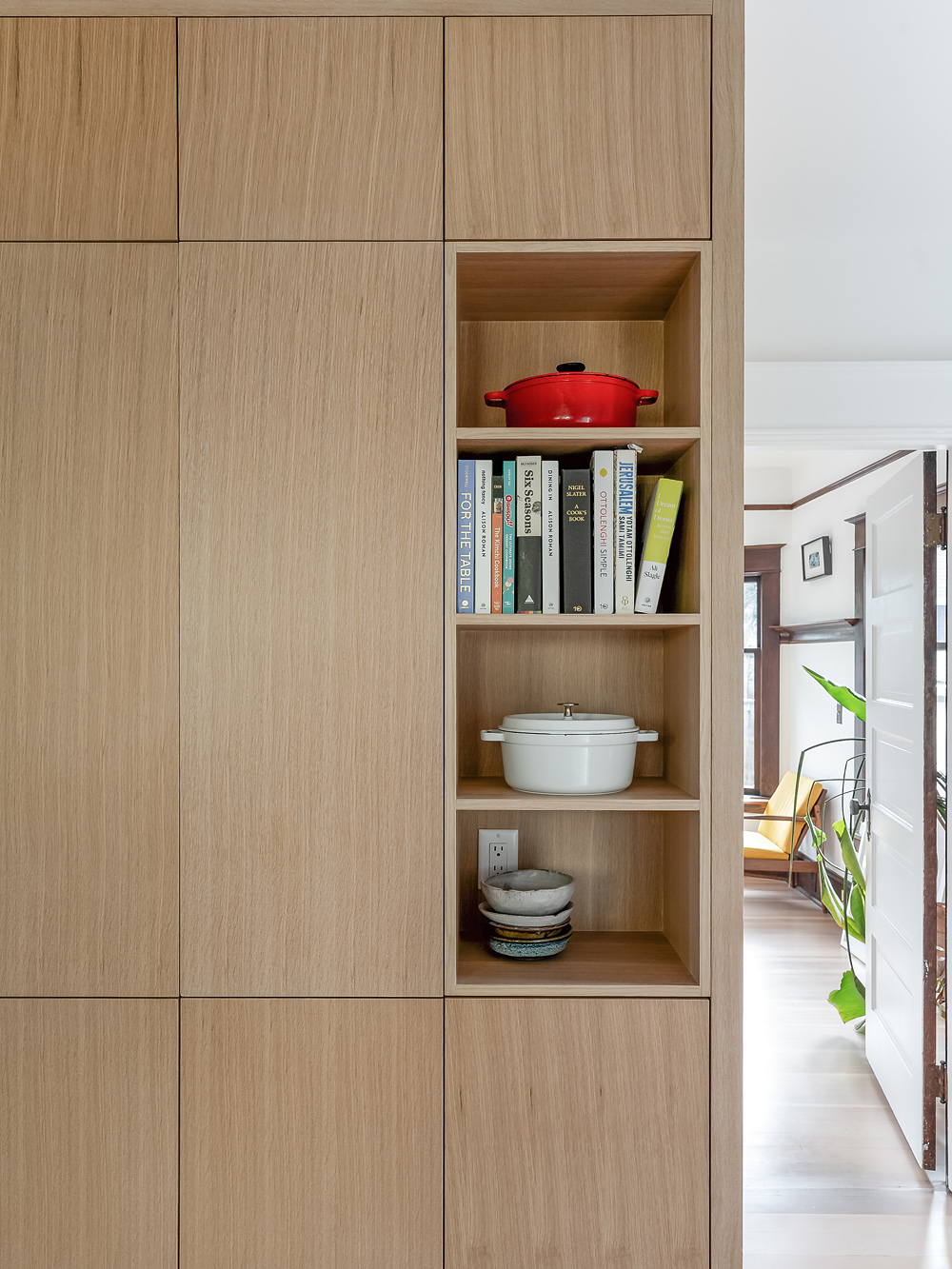 Full-height white oak cabinet wall with built-in open shelving, looking toward the living room, Alameda Kitchen by Tweto Architecture