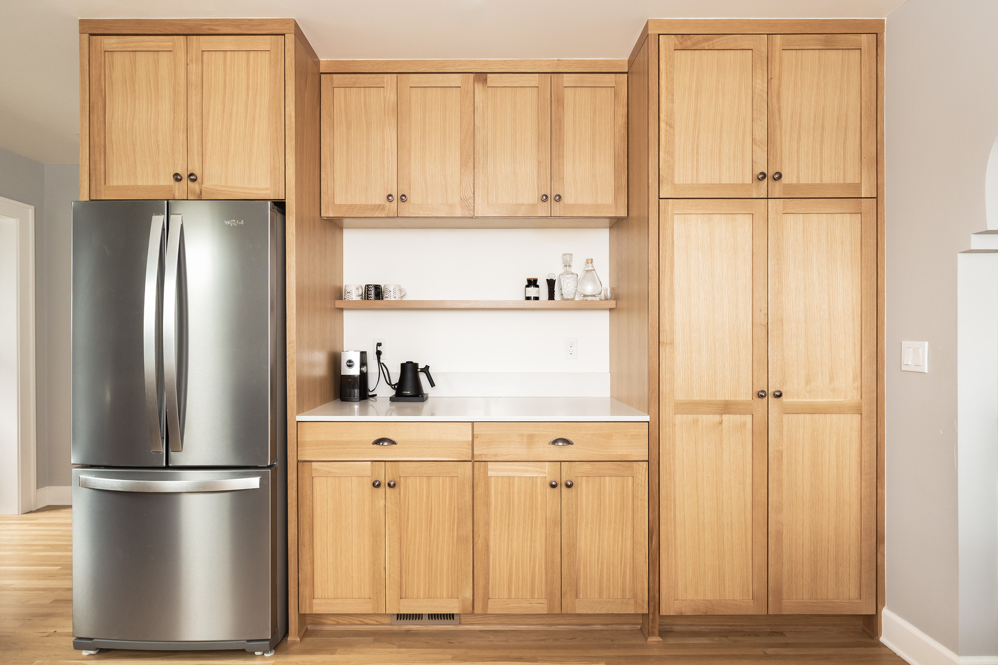 Pantry wall with refrigerator, floor-to-ceiling white oak cabinets, and dedicated coffee station with open shelf below upper cabinets, Arbor Lodge Kitchen remodel by Tweto Architecture
