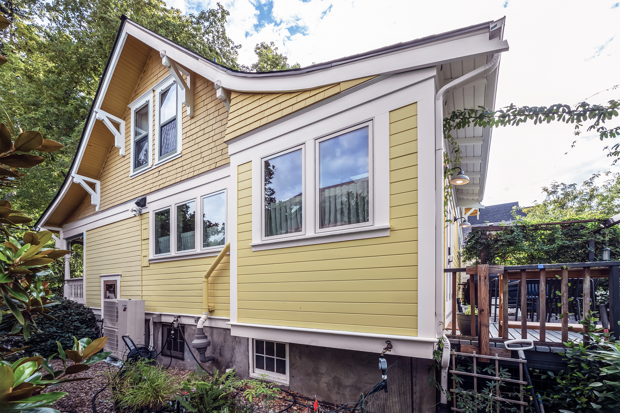 Rear exterior of the 1910 North Portland farmhouse after remodel, showing the rebuilt rear addition at lower right, Baldwin Street remodel by Tweto Architecture