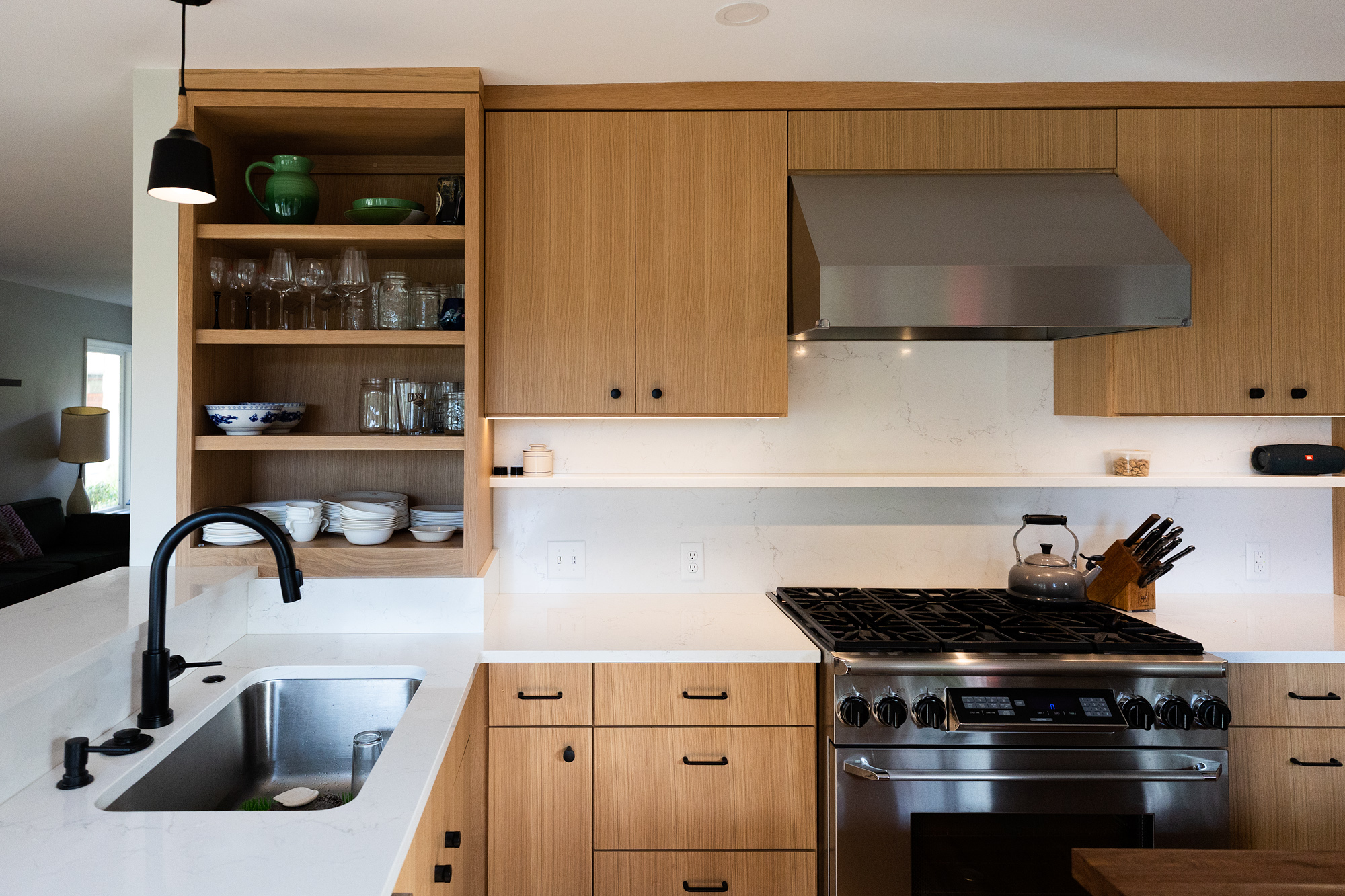 Range and open shelves with sink at left and walnut island countertop in foreground, Brooklyn Street kitchen remodel by Tweto Architecture