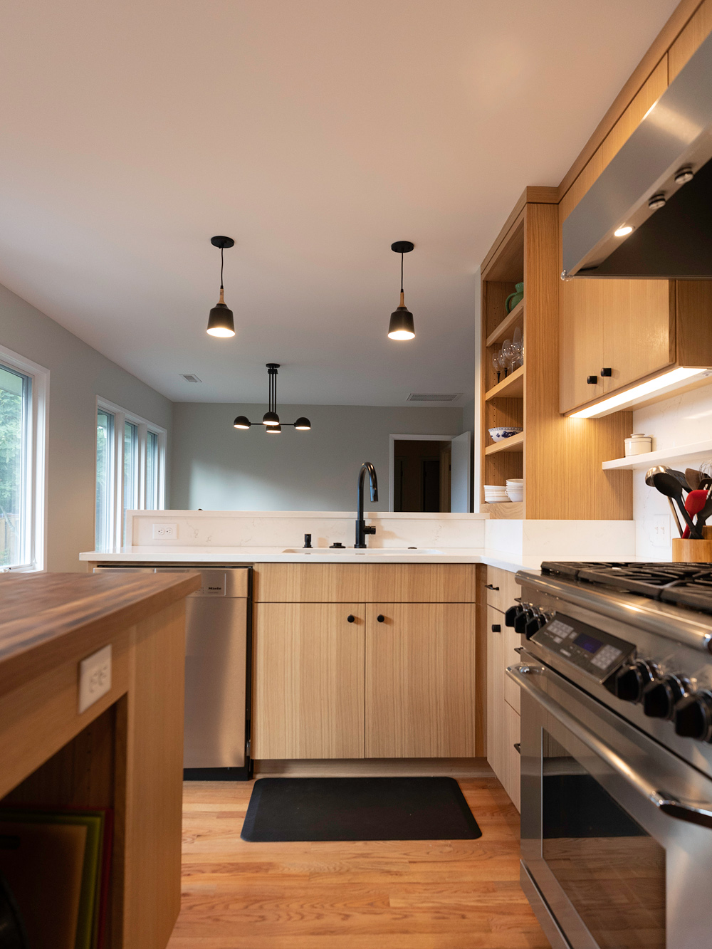 Kitchen from range side looking toward peninsula and south casement windows, Brooklyn Street remodel by Tweto Architecture