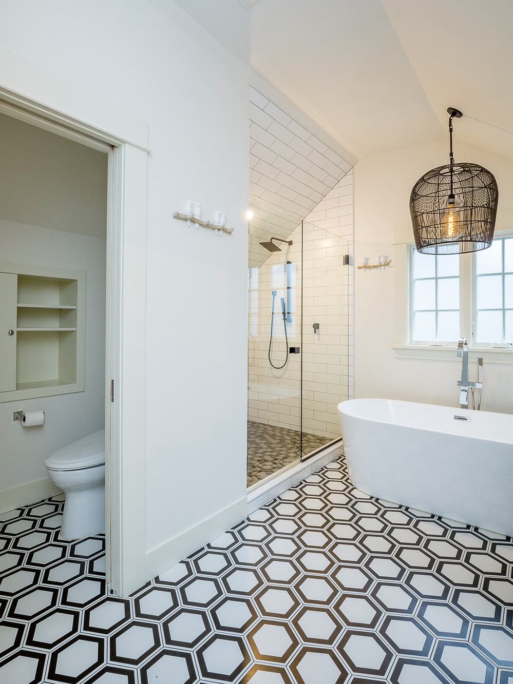 Wide view of primary bath showing toilet room at left, tile shower, and soaking tub, Carolina Primary Suite addition by Tweto Architecture