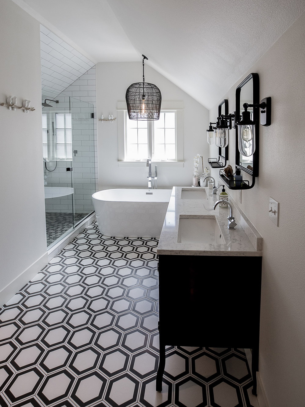Full room view of primary bath with freestanding soaking tub, double vanity, hexagon tile floor, and tile shower at left, Carolina Primary Suite addition by Tweto Architecture