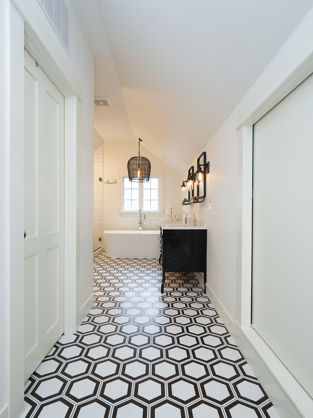 Passage looking through to primary bath with hexagon tile floor and soaking tub beyond, Carolina Primary Suite addition by Tweto Architecture
