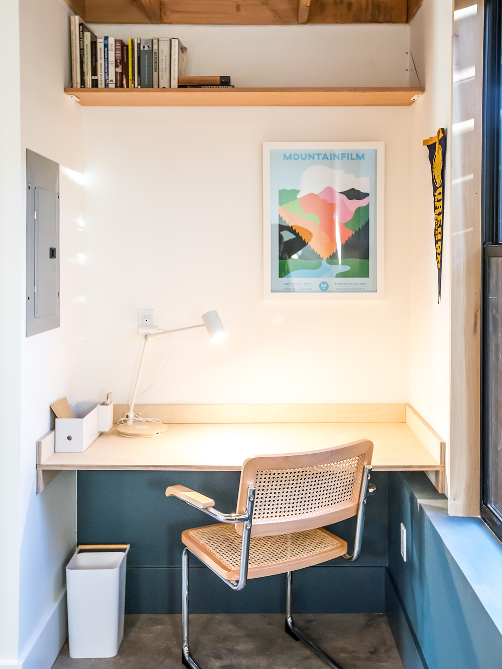 Built-in desk nook in the loft with butcher block surface, task lamp, and floating shelf above, Mason Street ADU by Tweto Architecture