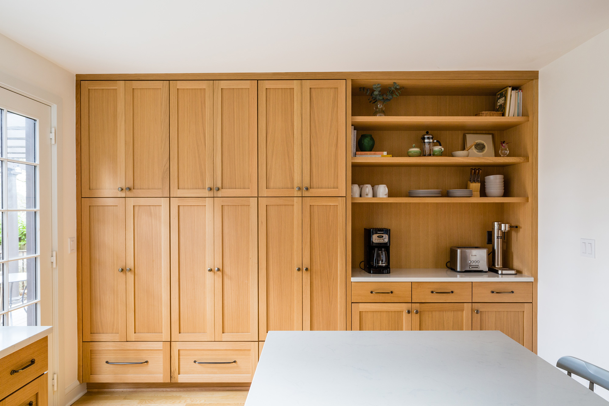 Full-height storage wall with tall oak cabinets and open shelves with coffee station, Mt. Tabor Tudor remodel by Tweto Architecture