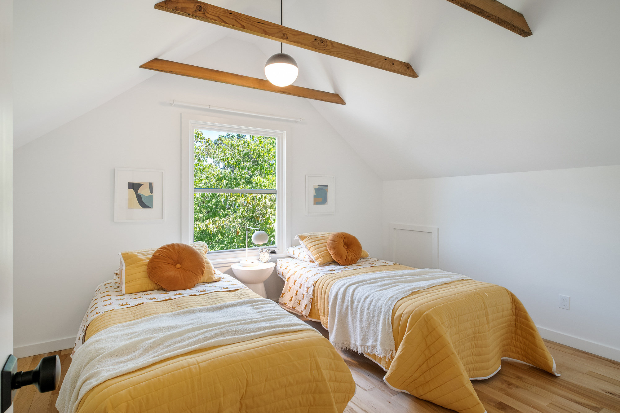 Attic children's bedroom with twin beds under vaulted ceiling and tree views through the window, NE 9th Remodel by Tweto Architecture, NE Portland