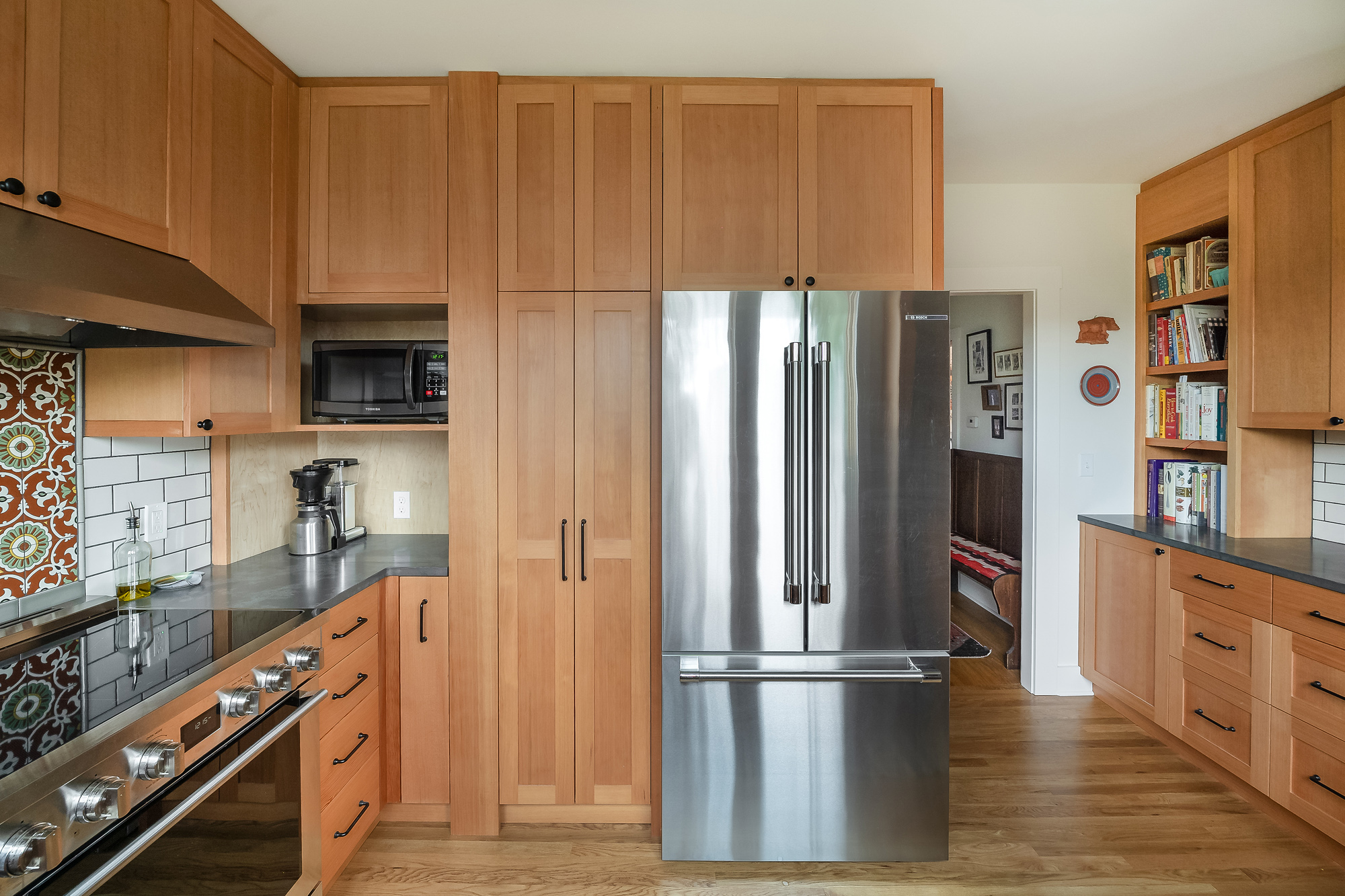 Full-height cabinet wall closed concealing the stair soffit, Sabin Kitchen by Tweto Architecture