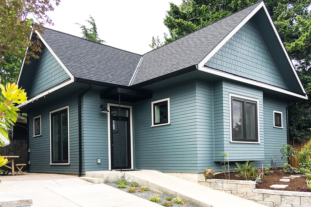 Siskiyou Street Recording Studio exterior, blue-green accessory structure with gable roof and stone retaining wall, Beaumont neighborhood Portland by Tweto Architecture