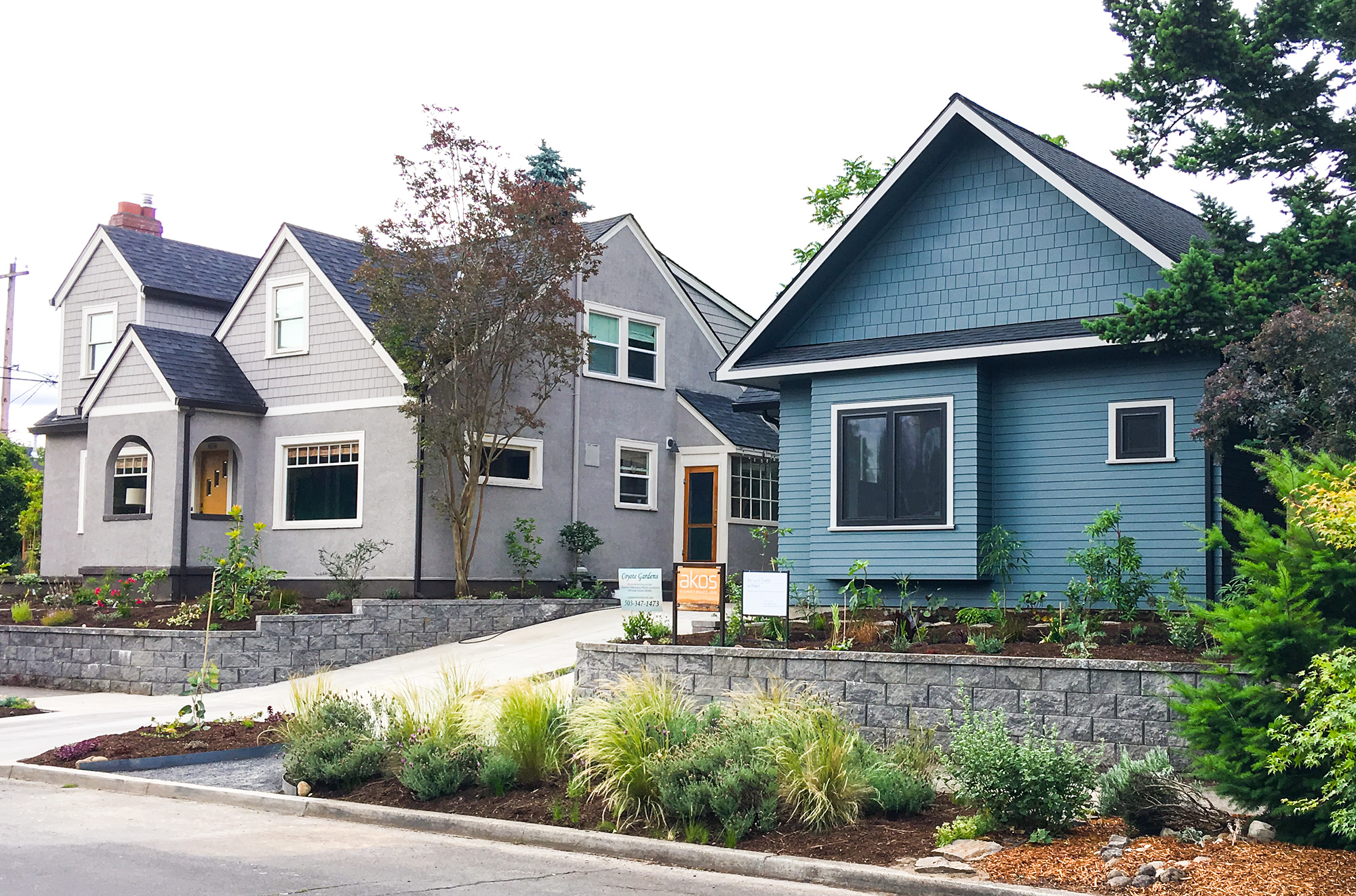 Street view showing the recording studio beside the main house, with stone retaining walls and new landscape plantings in the foreground, Beaumont neighborhood Portland, by Tweto Architecture