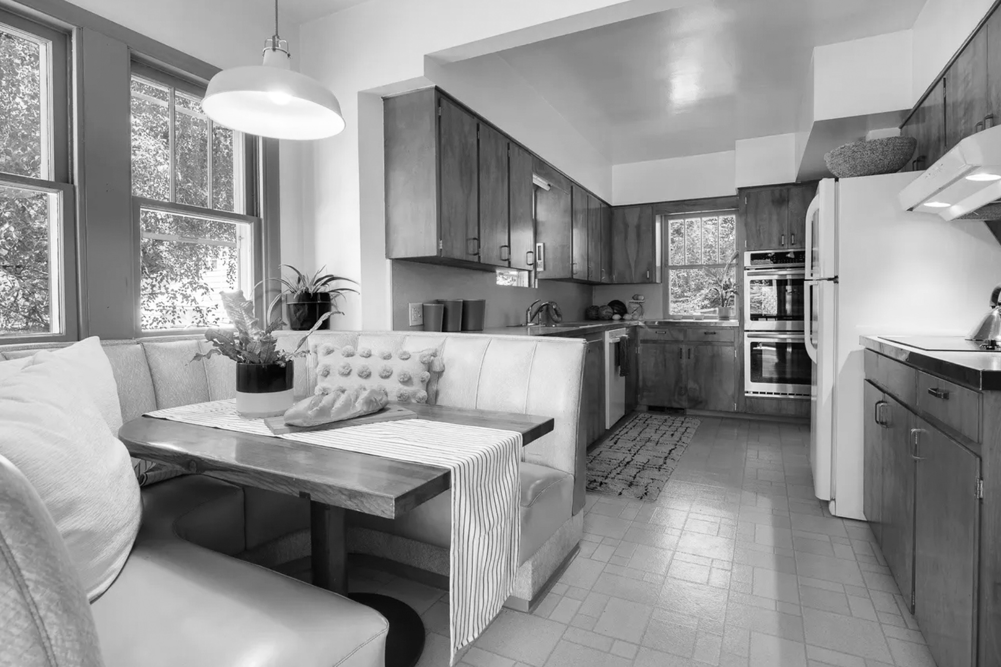 Existing kitchen before remodel showing dark 1960s cabinetry, dated breakfast nook, and cluttered galley layout, Stanton Street Kitchen by Tweto Architecture